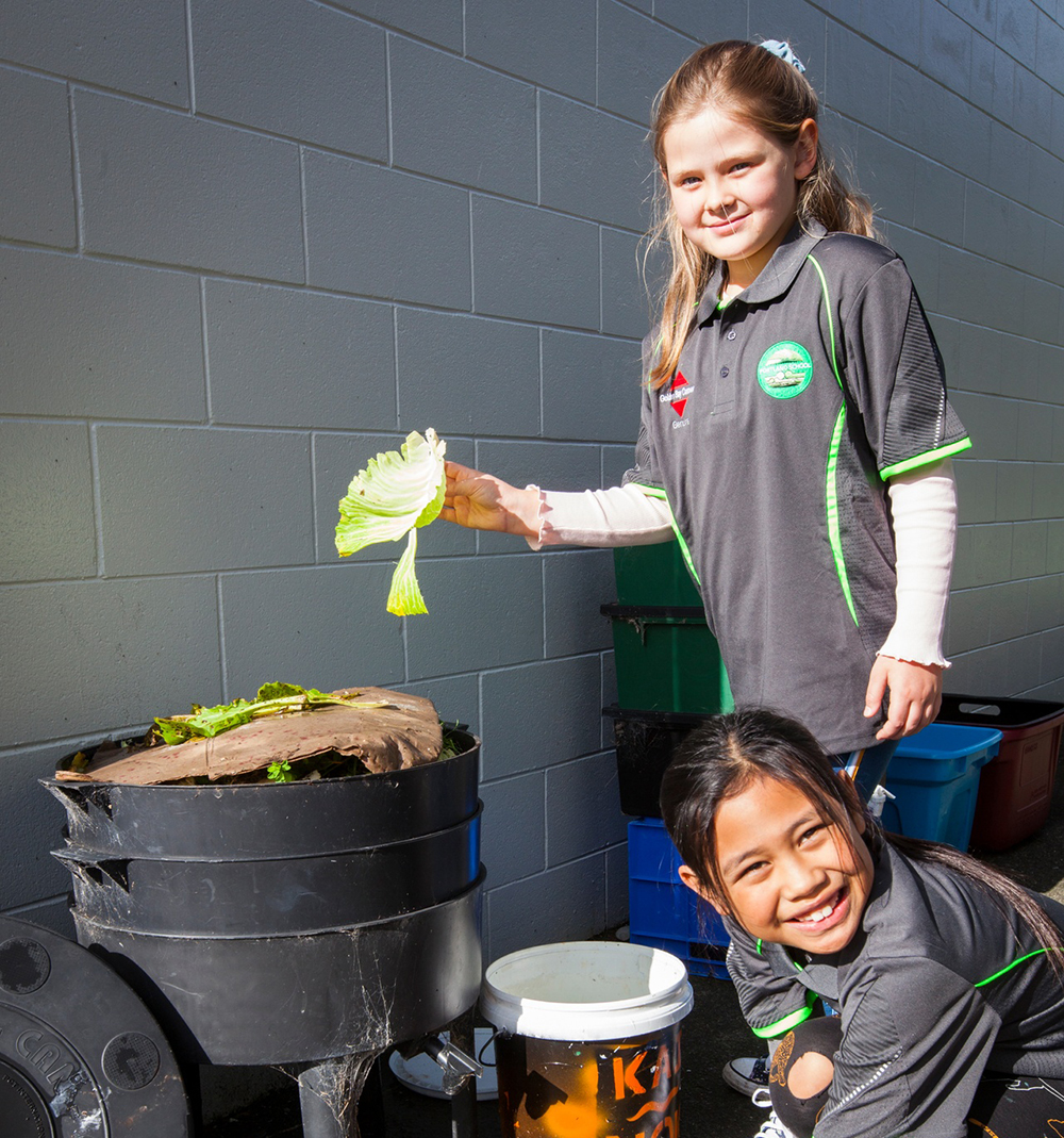 Two children with compost.