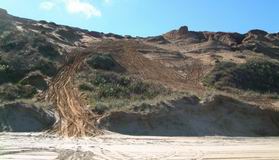 Vehicle damage on West Coast dunes.