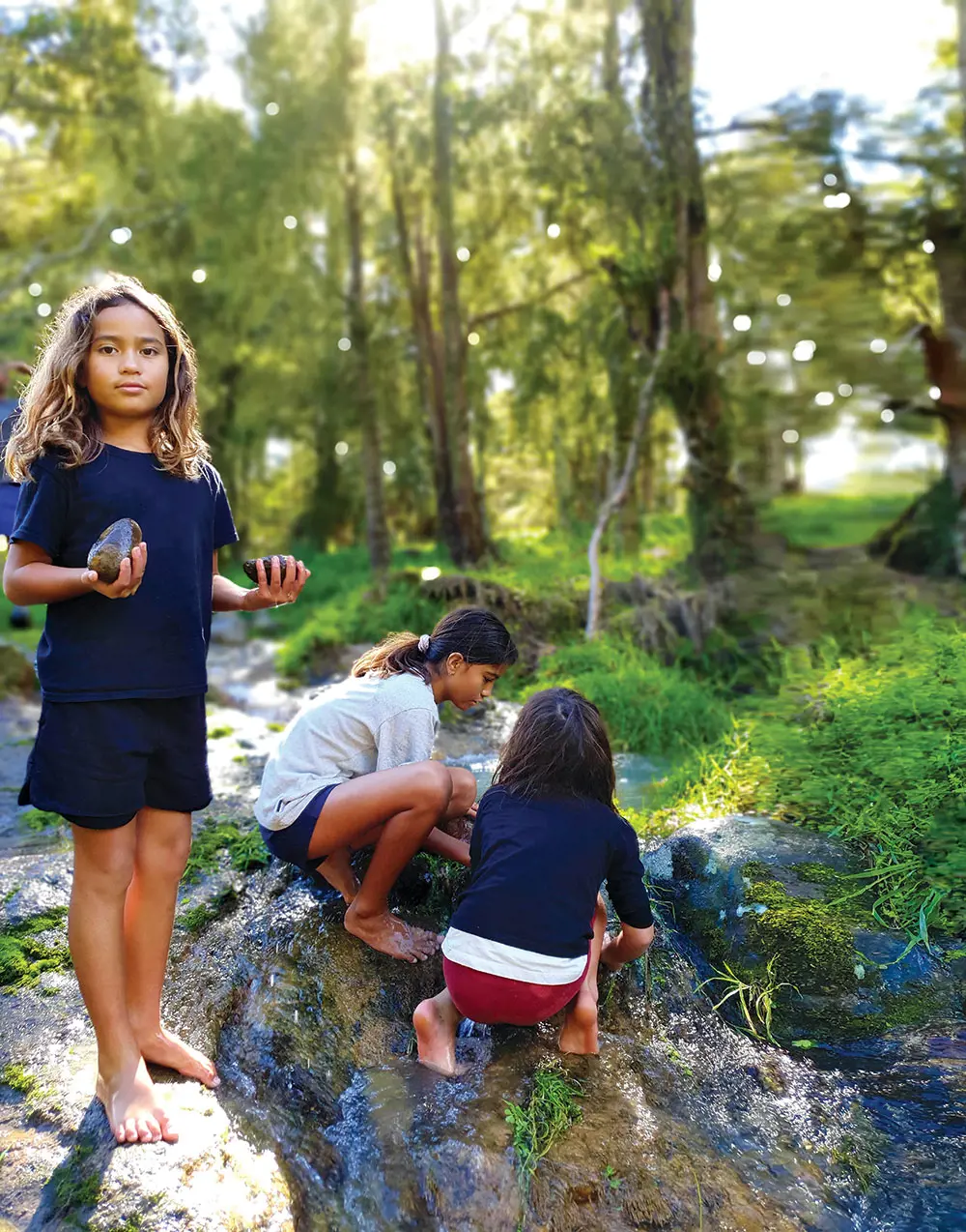 Children by freshwater stream.