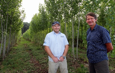 Wayne Teal and Coulcillor Rick Stolwerk standing in front of a row of poplars.