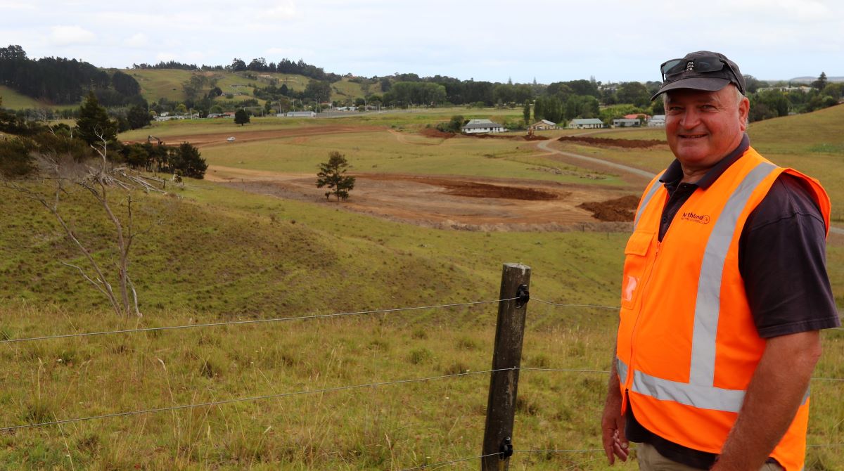 Regional council Kaitaia Area Manager Peter Wiessing on a hill overlooking the 2.4 hectare southern spillway construction site in mid-January.