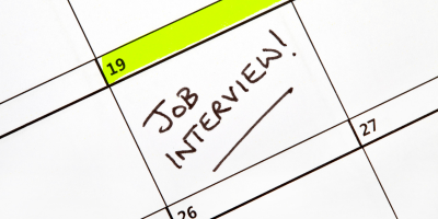 Calendar with green highlight over date with job interview written underneath.