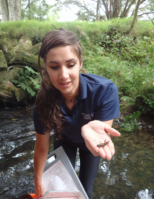 Woman with macroinvertebrate on her hand.