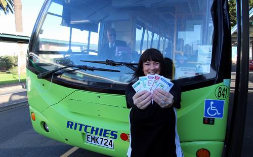 Transport Coordination Officer Anita Child holding bus route brochures.