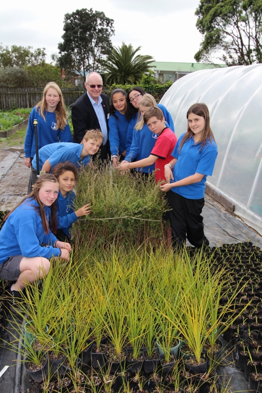 Bill Shepherd checks out riparian plants grown by the students.jpg