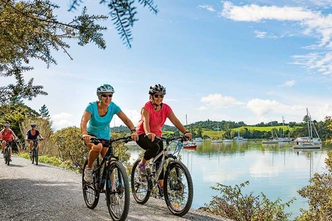 Women cycling along the waterfront.