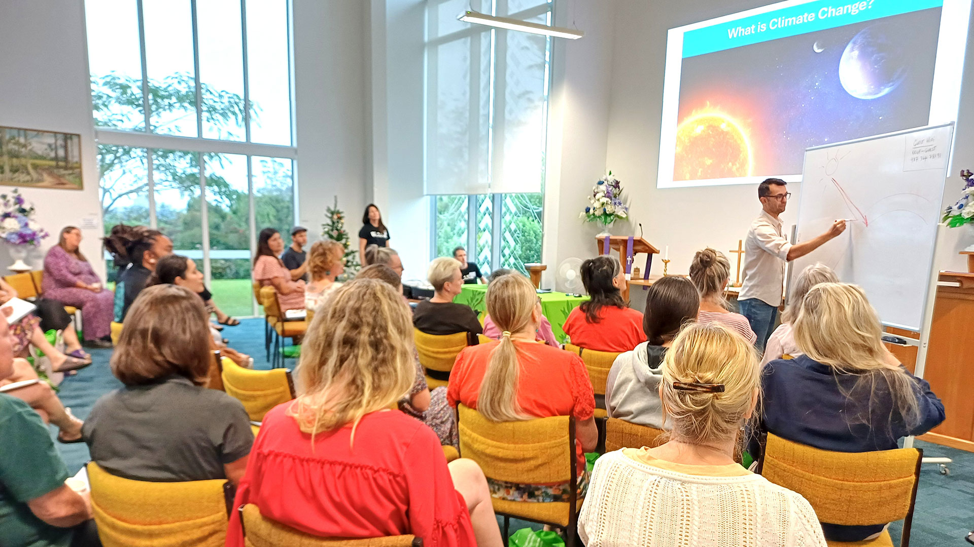 Rakesh Pinao presents an introductory climate science session on a projector screen.
