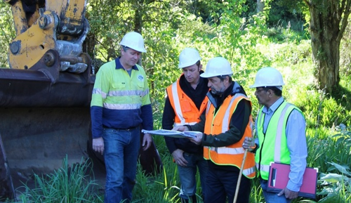 Men wearing hard hats and high viz vests.