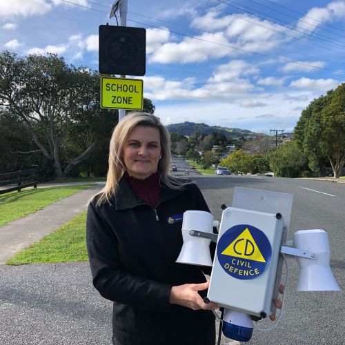 Woman holding tsunami siren.