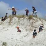 Children playing on sand dunes.