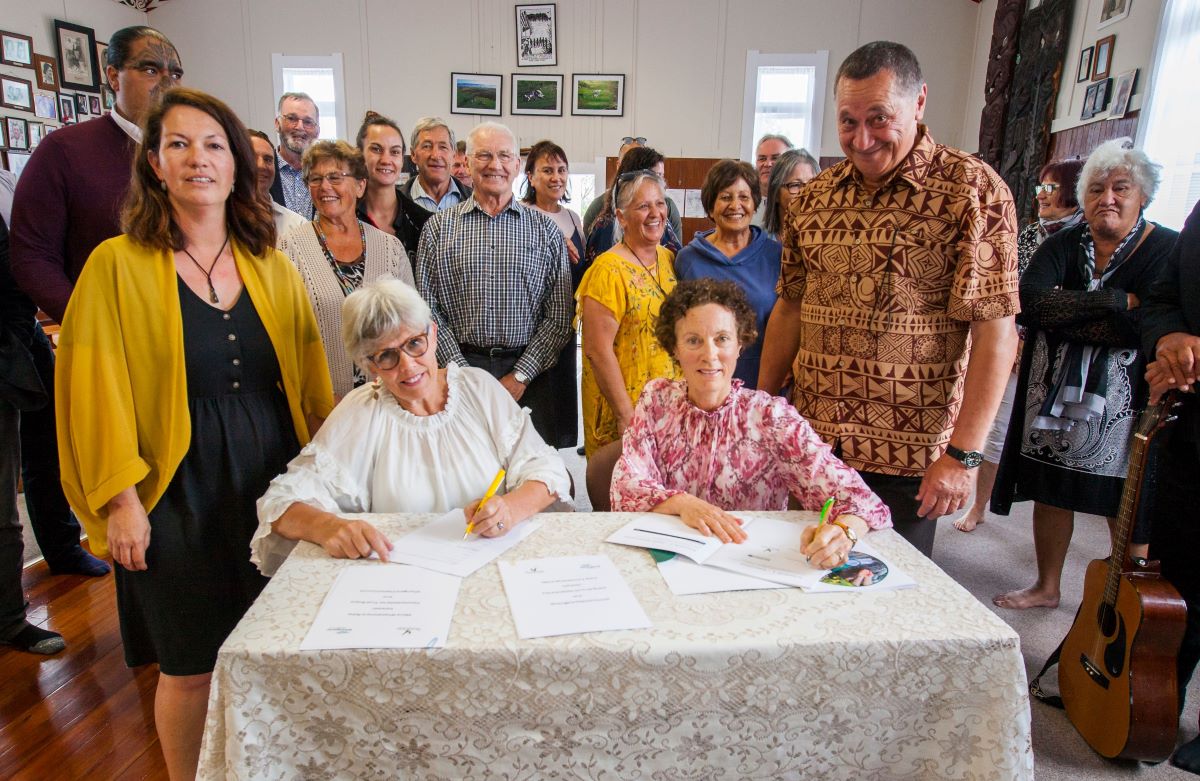 Whangārei Mayor Sheryl Mai, (seated left) and Northland Regional Council Chair Penny Smart sign the Manawhakahono ā Rohe agreements at Takahiwai Marae at the weekend.  Standing beside them are Juliane Chetham, Patuharakeke Trust Board’s Environmental/Taiao Unit Manager, left, and the board’s Interim Chair Gilbert Paki.