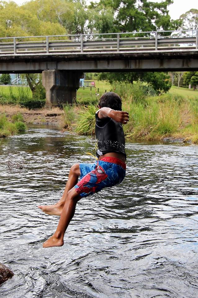Boy jumping into the river.