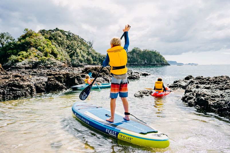 Children on kayaks and paddleboard.
