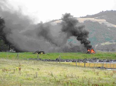 Smoke nuisance from burning tyres & plastic wrap.