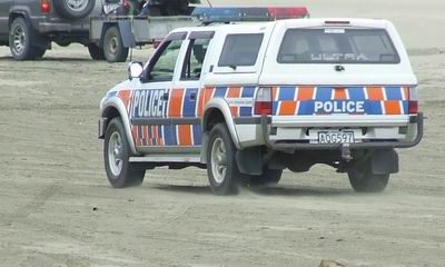 Police 4WD vehicle on Ahipara Beach.