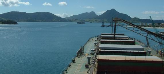 Ship being loaded by a crane.