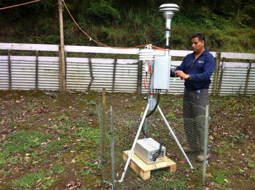 NRC officer checking air quality monitoring equipment.