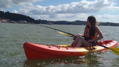 Woman fishing in kayak.