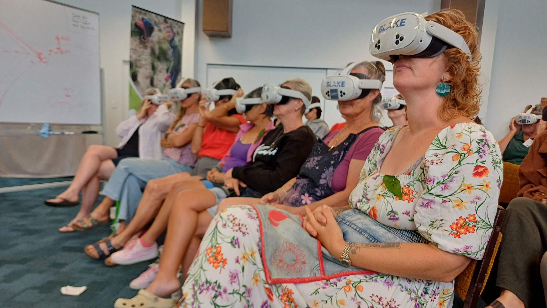 Educators sitting in a row wearing virtual reality headsets.