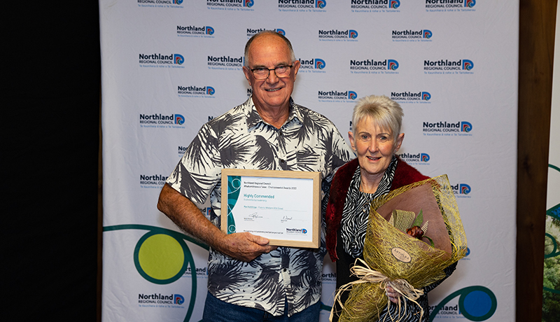 Man and woman with prizes.