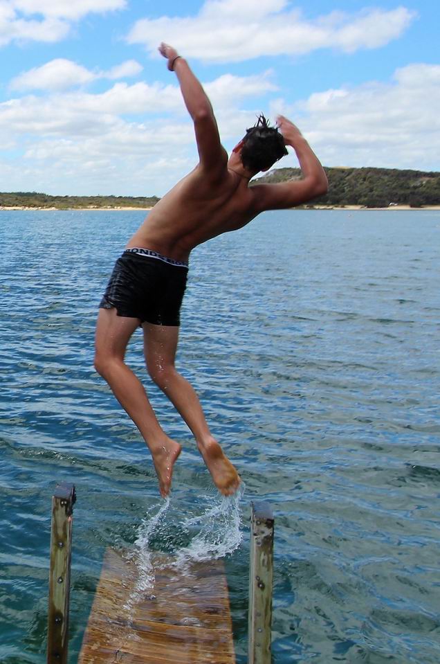 Boy jumping into the lake.