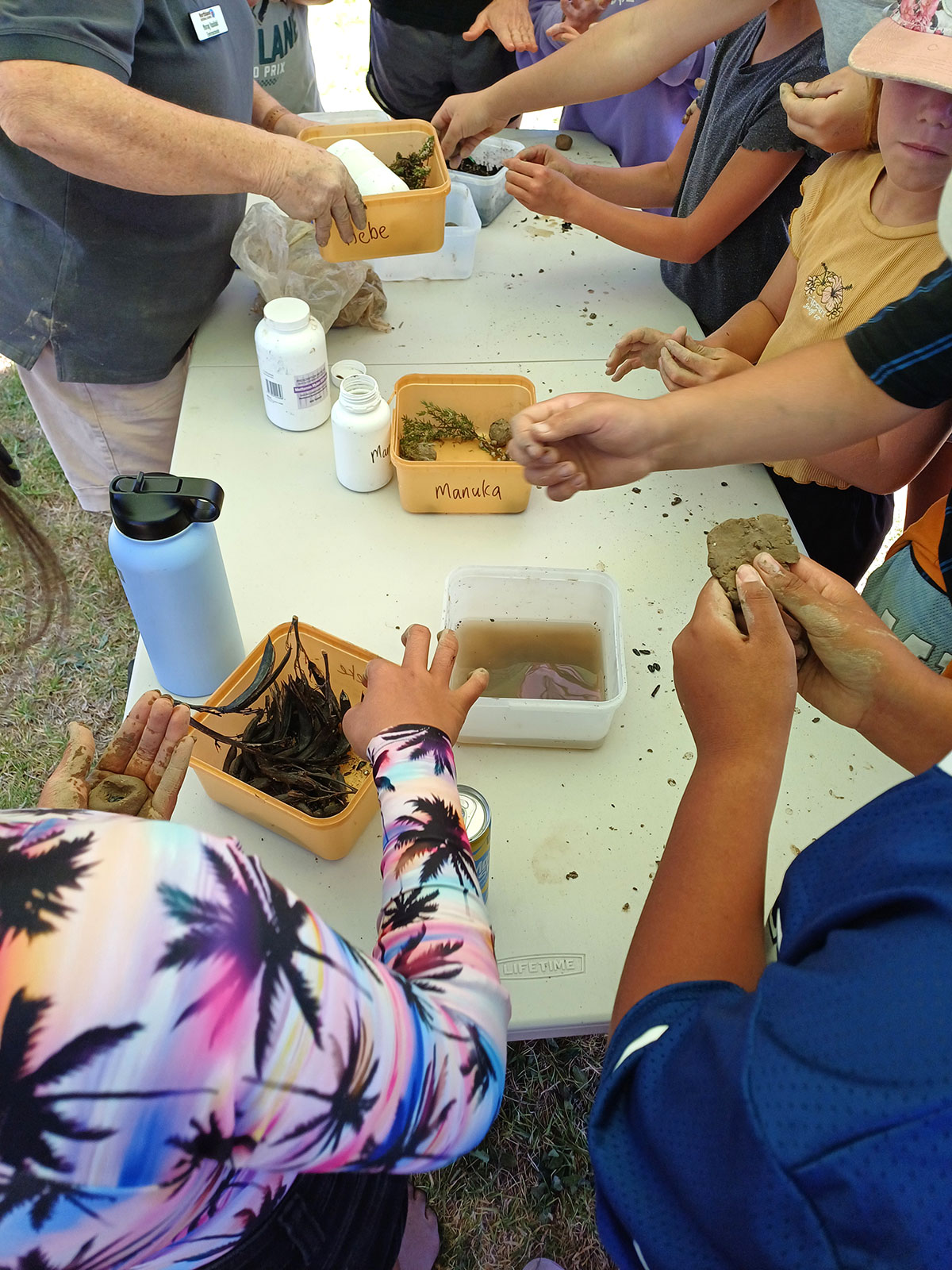 People doing an activity on a table.