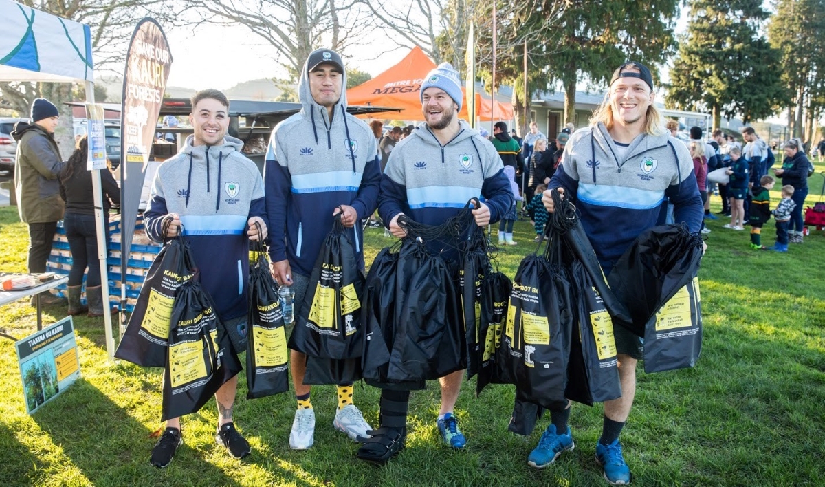 Northland's Taniwha rugby team members with boot bags to give away.