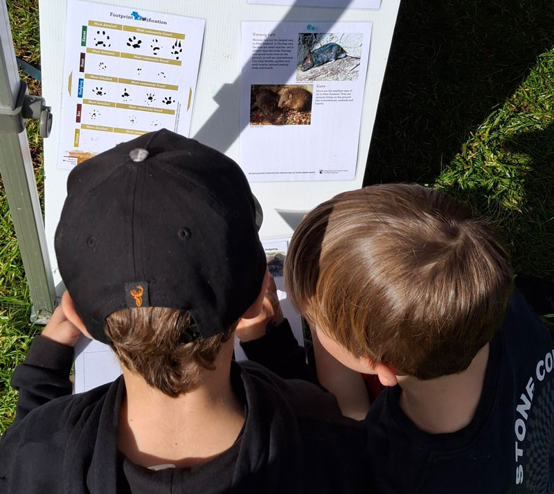 Two children looking at paper.