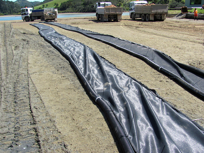Silt curtains laid out on the beach