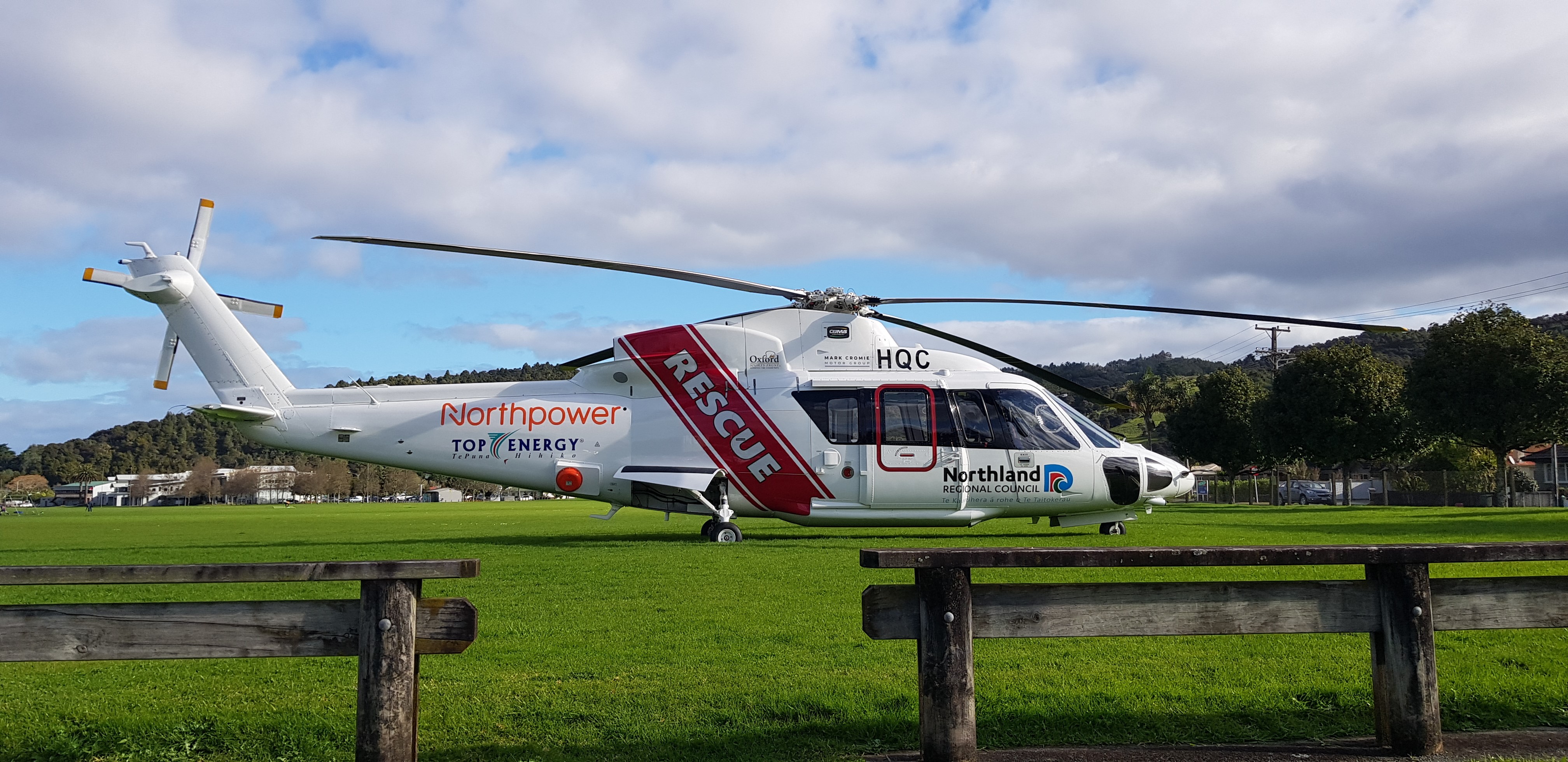 The Northland Rescue Helicopter, landed on the ground in a field.