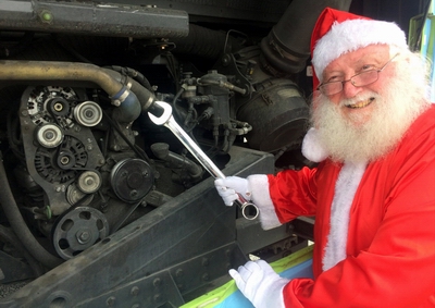 Santa tuning a bus engine.