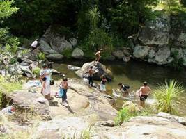 Families enjoy swimming at Raumanga Stream, Whangarei.