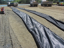 Silt curtains laid out on beach.