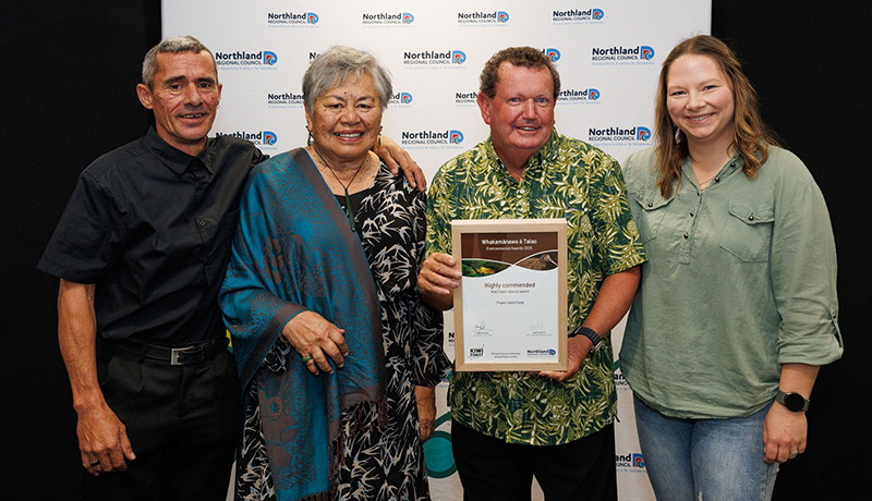 Two men and two women with a certificate in front of Northland Regional Council logo backdrop. (Photo: Dawn Dutton Photography).