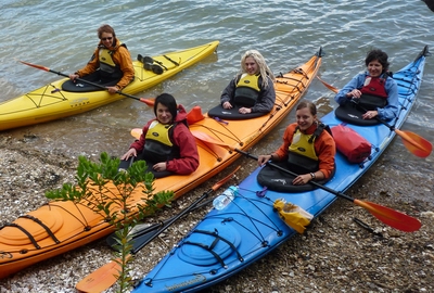 Women in kayaks.