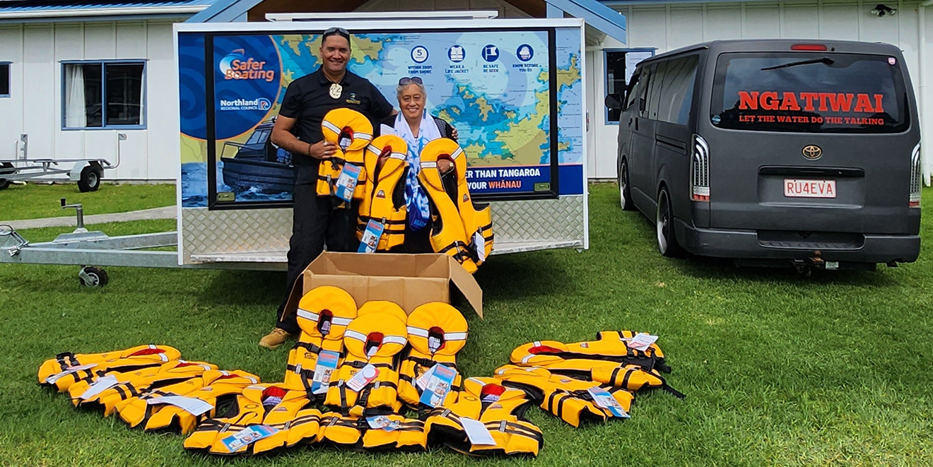 Man and woman surrounded by lifejackets.