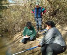 Volunteers taking water samples of the Utakura River.