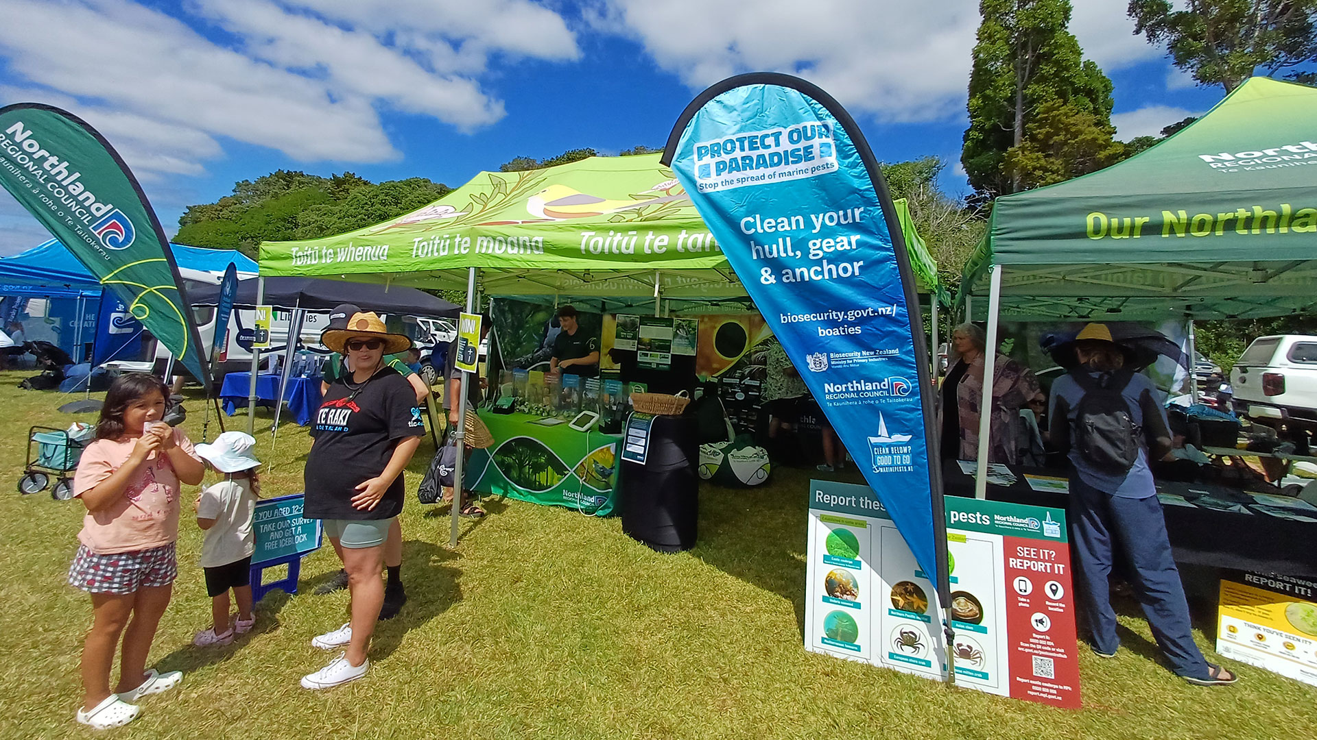 People standing in front of gazebos at a previous Waitangi Day festival.