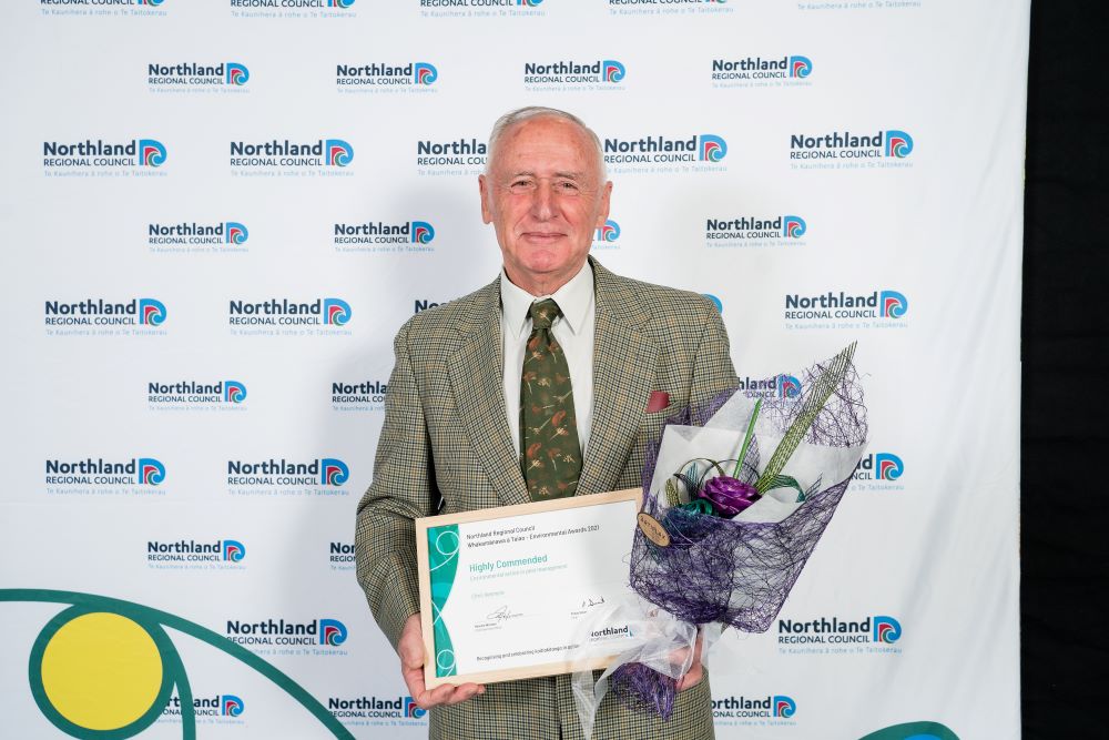 Chris Venmore with certificate and bouquet.