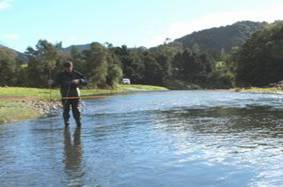 Staff member using a mechanical flow meter to measure water flows.