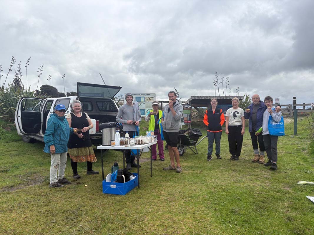 A group of volunteers enjoy refreshments at a planting day.