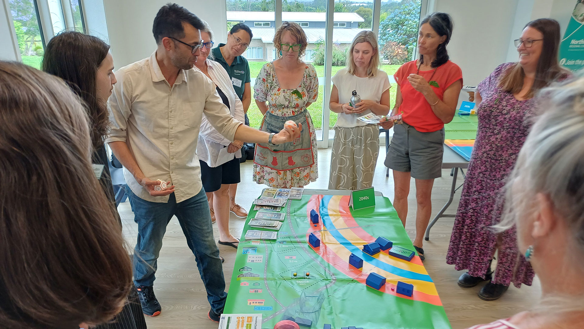 Participants gather around an interactive map and learning materials.