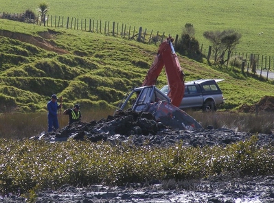 Digger stuck in mud.