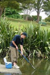 NRC Monitoring Officer taking water samples.