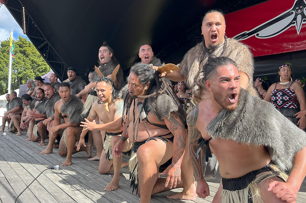 People performing kapa haka on a stage.