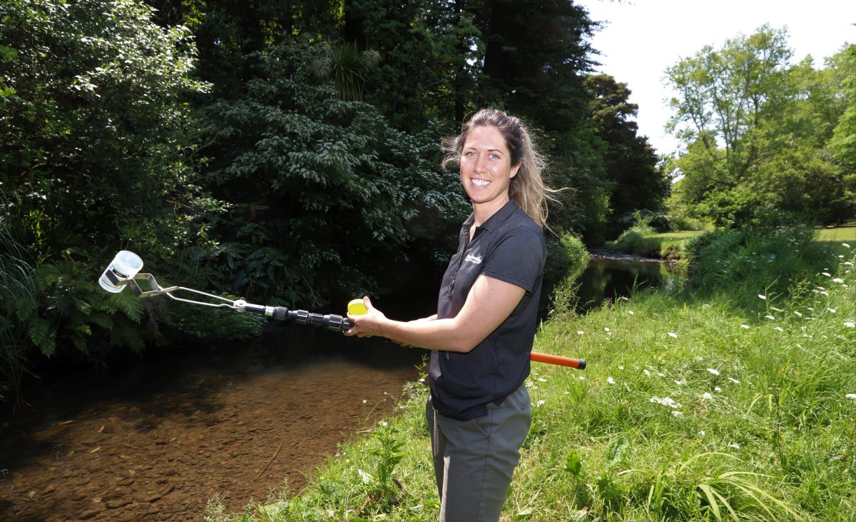 Environmental Monitoring Officer Jo Skyrme takes a sample from Whangarei’s Raumanga Stream; one of the places sampled as part of the regional council’s annual summer swim spot water quality testing programme.