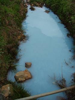 Paint pollutes a stream.