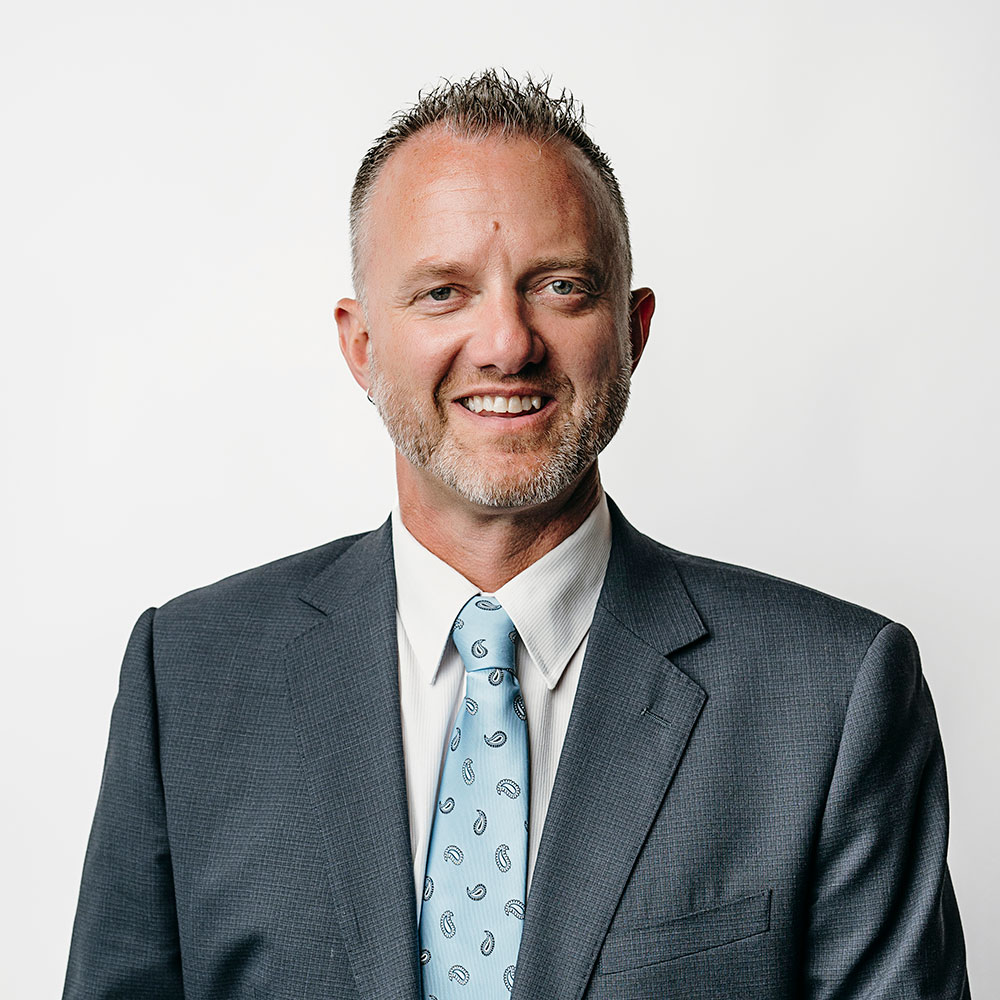 Jason Marris wearing a suit and tie.