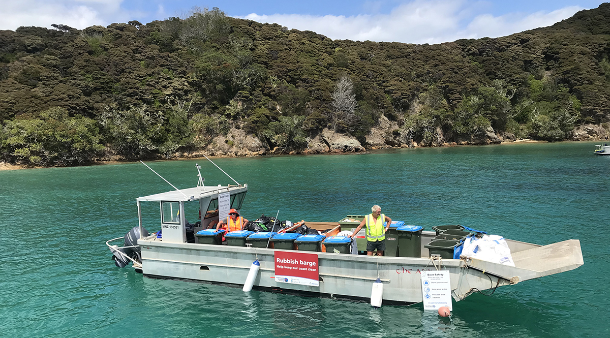 The popular mobile summer rubbish barge on the water in the Bay of Islands.