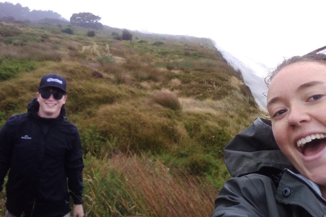 Heidi Lowe and Jared Mills (summer interns) in the wind and rain.